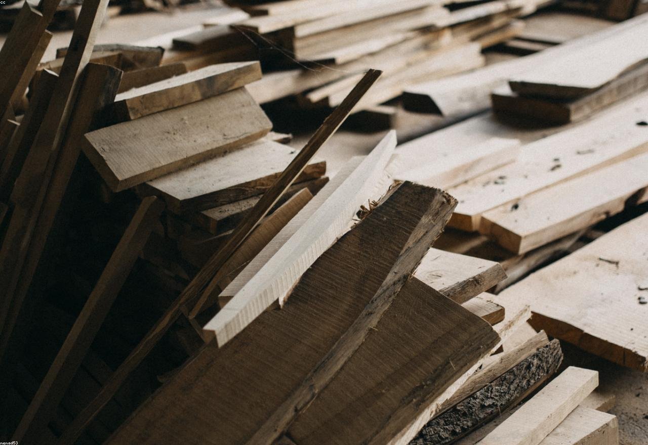 Stacked timber and construction material at a building site